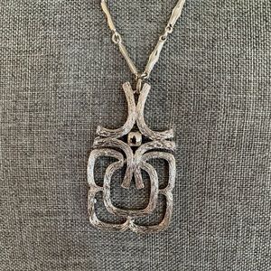 Avon silver pendant. Excellent condition with articulated pendant.